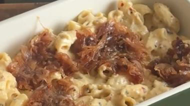 Baked caramelised onion mac and cheese topped with melted cheddar and breadcrumbs
